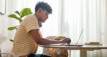 Online student working on laptop from home